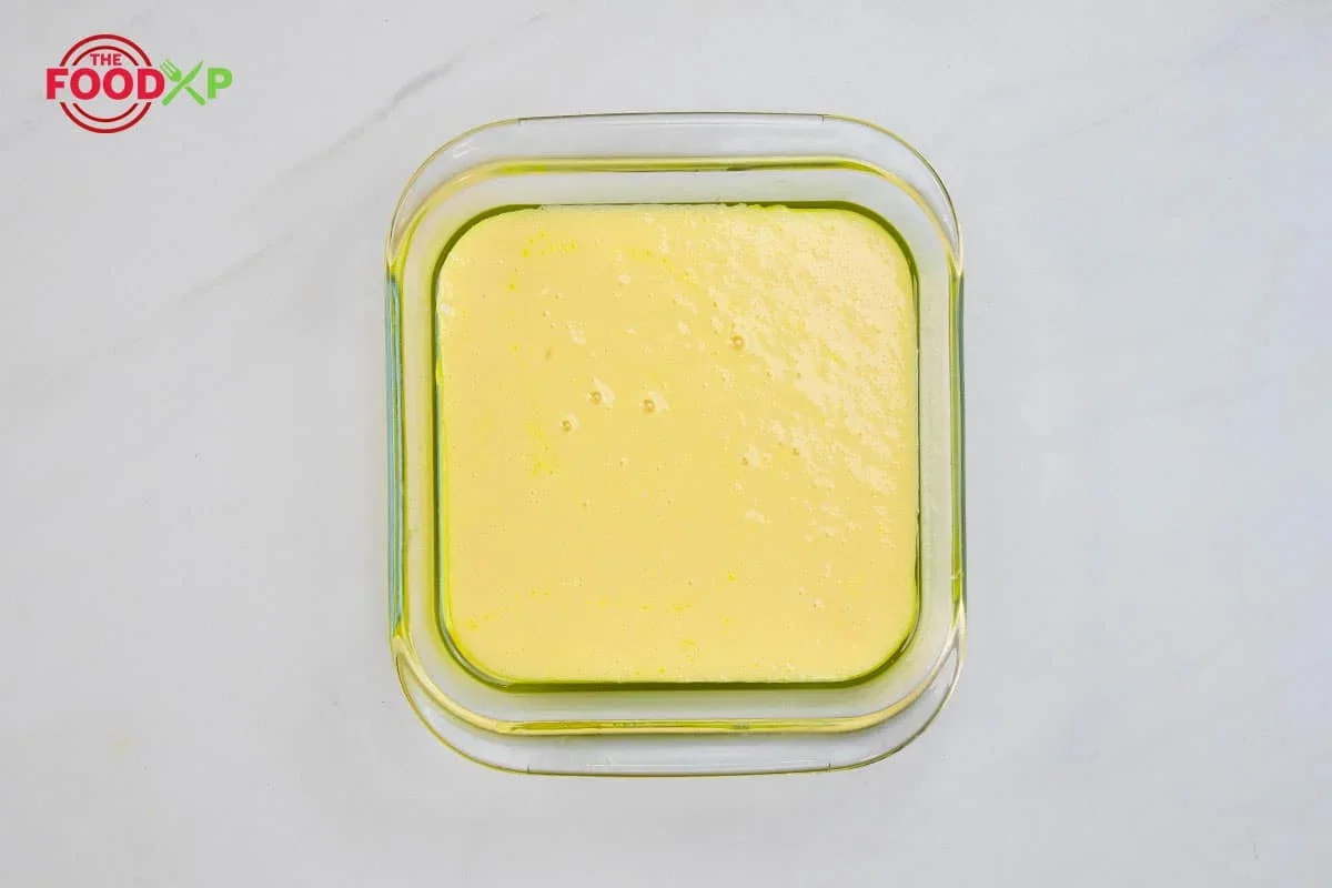 Step 1.1: Lightly grease a 13×9″ baking dish with unsalted butter and dust with all-purpose flour, tapping out excess