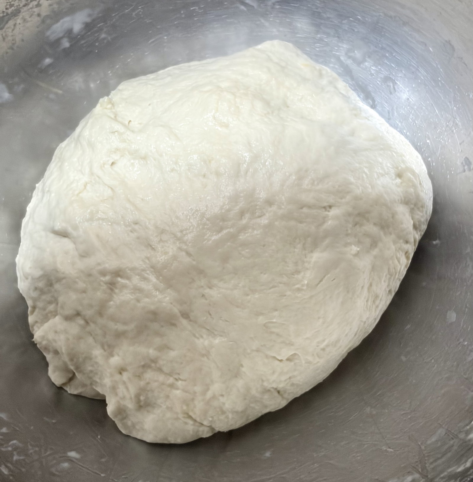 Step 2.2: Add melted butter and knead vigorously for 8–10 minutes until the dough becomes smooth and elastic