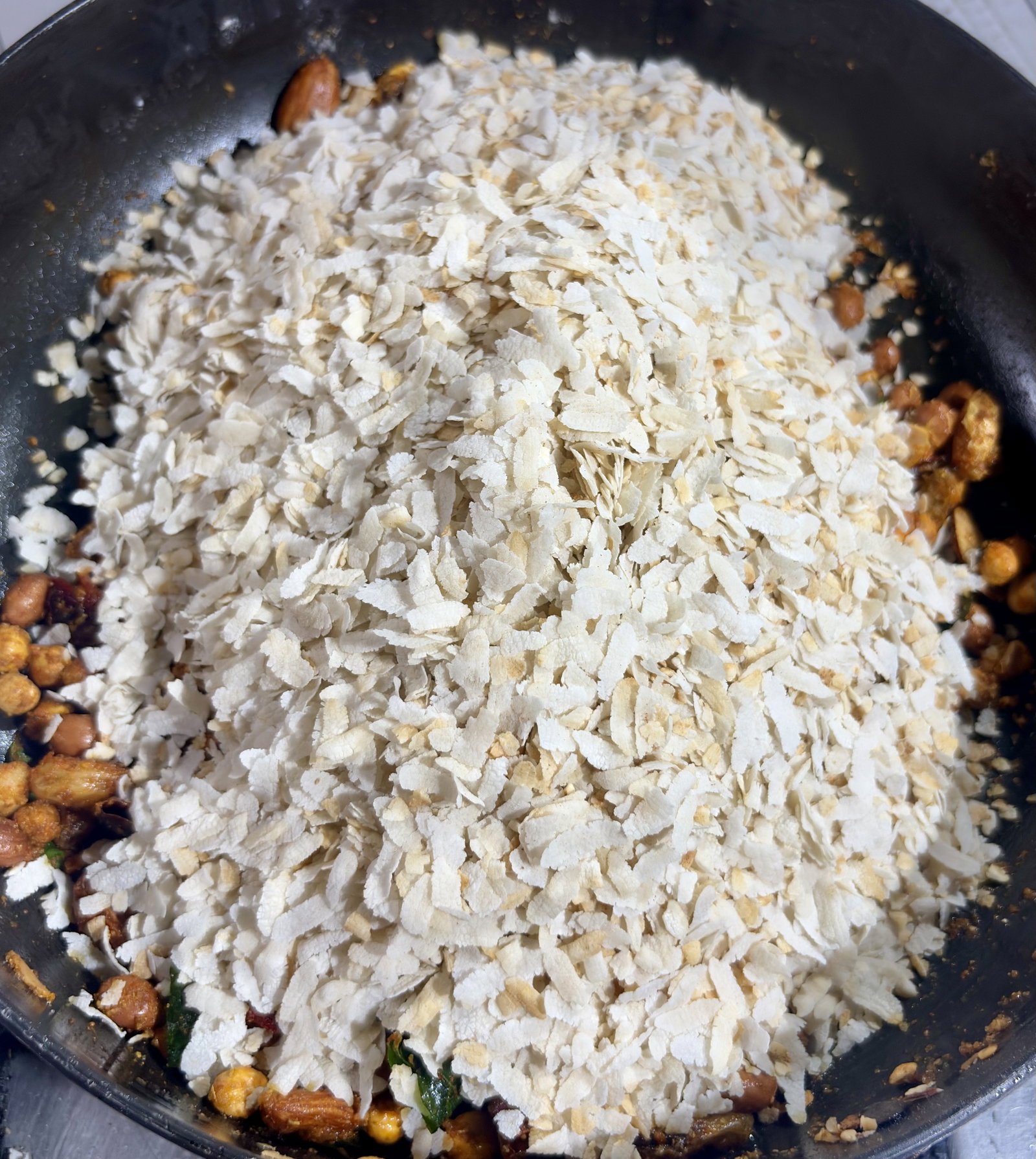 Step 4.1: Immediately add the roasted poha back into the pan