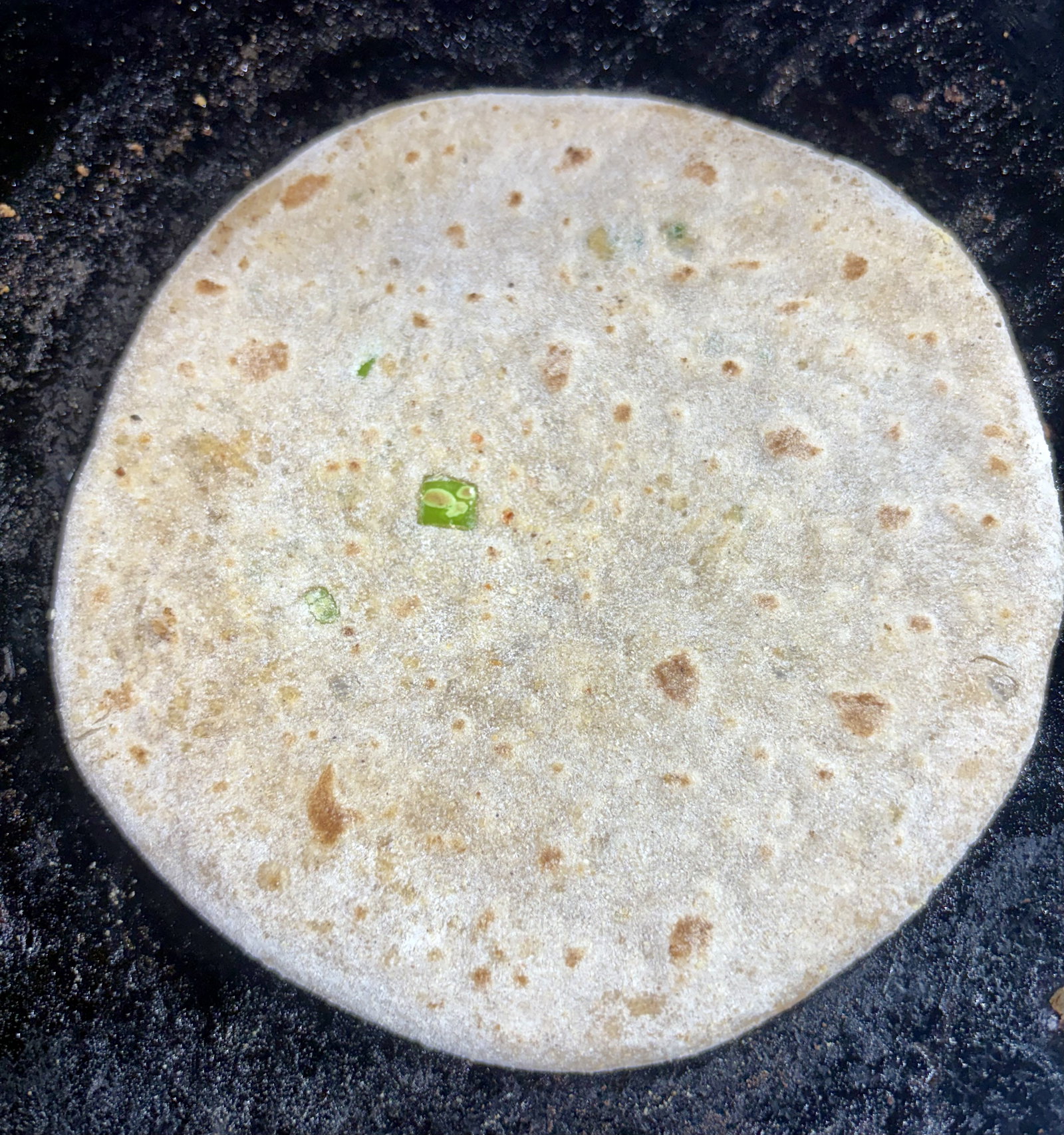 Step 4.1: Place the rolled paratha on the hot tawa