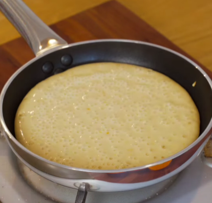 Step 2.1: Pour in the batter and cook gently until bubbles form and the surface is golden