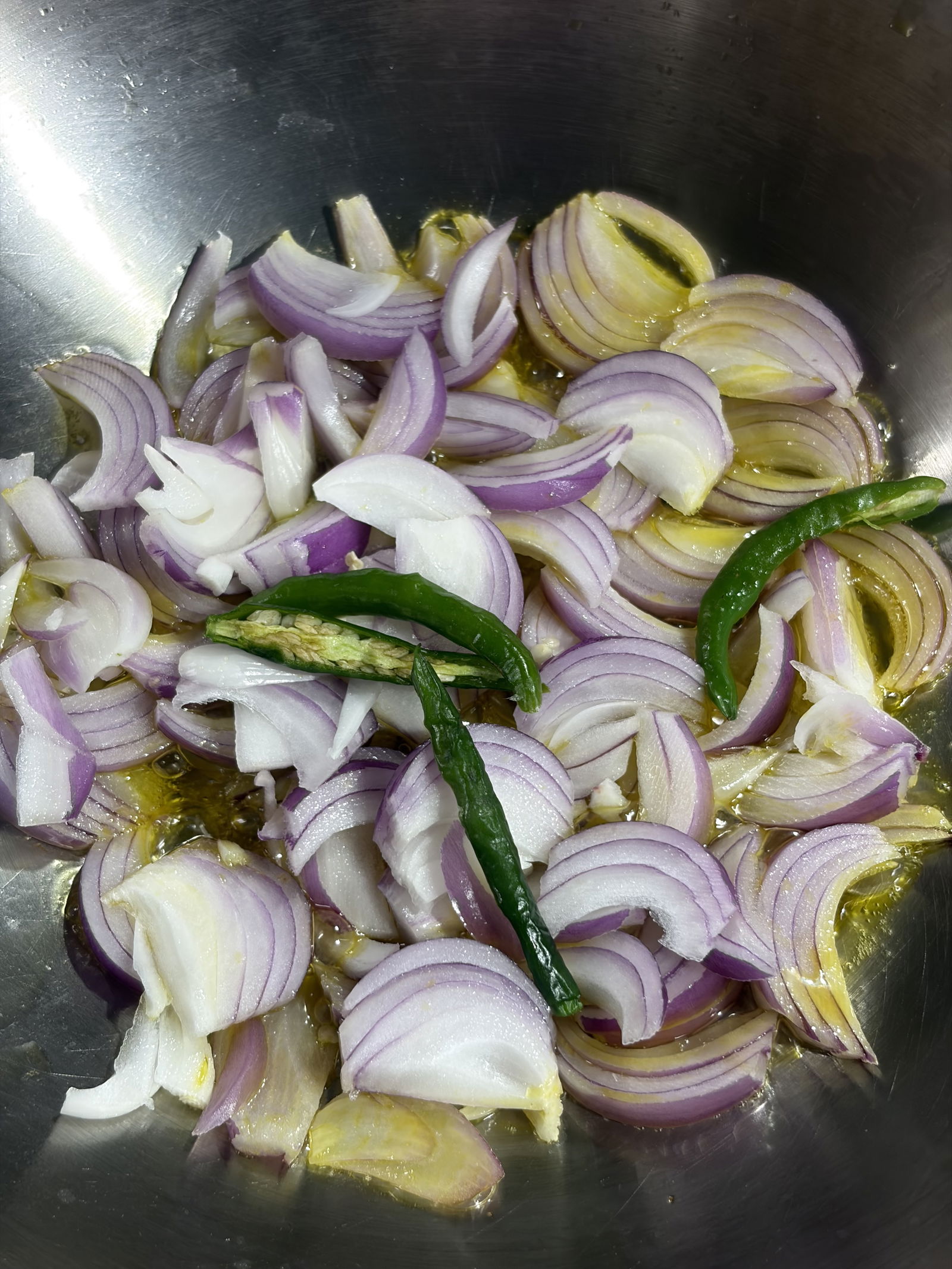 Step 3.1: Add the sliced onions and green chillies