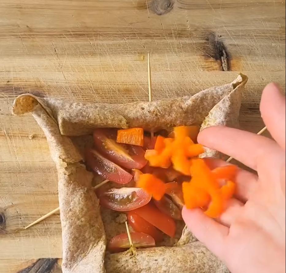 Step 1.1: Fill the center with chopped cherry tomatoes, diced orange or red pepper, and diced black olives