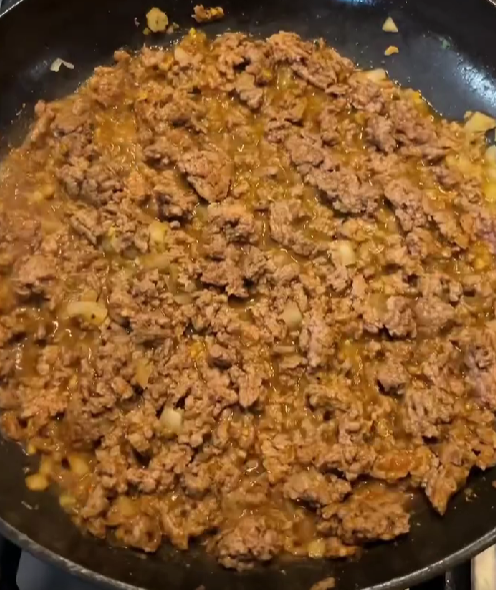 Step 4.1: Break up mince and cook until browned and liquid is reduced, achieving a saucy texture