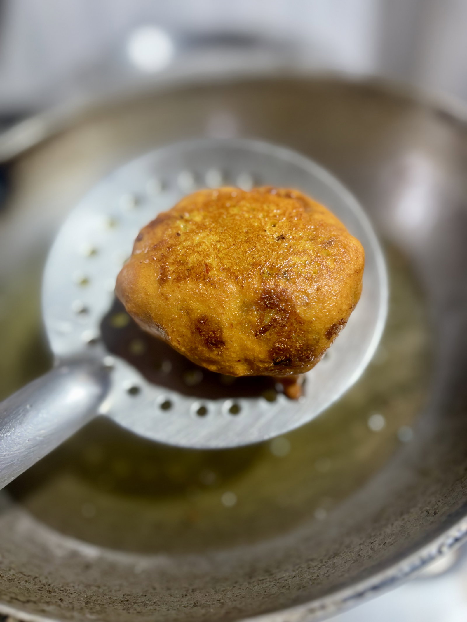 Step 3.1: Turn occasionally and fry until the vadas are crisp and golden brown