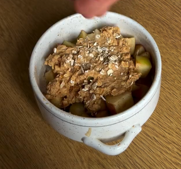 Step 3.1: Add the crumble topping over the softened apple mixture in the ramekin