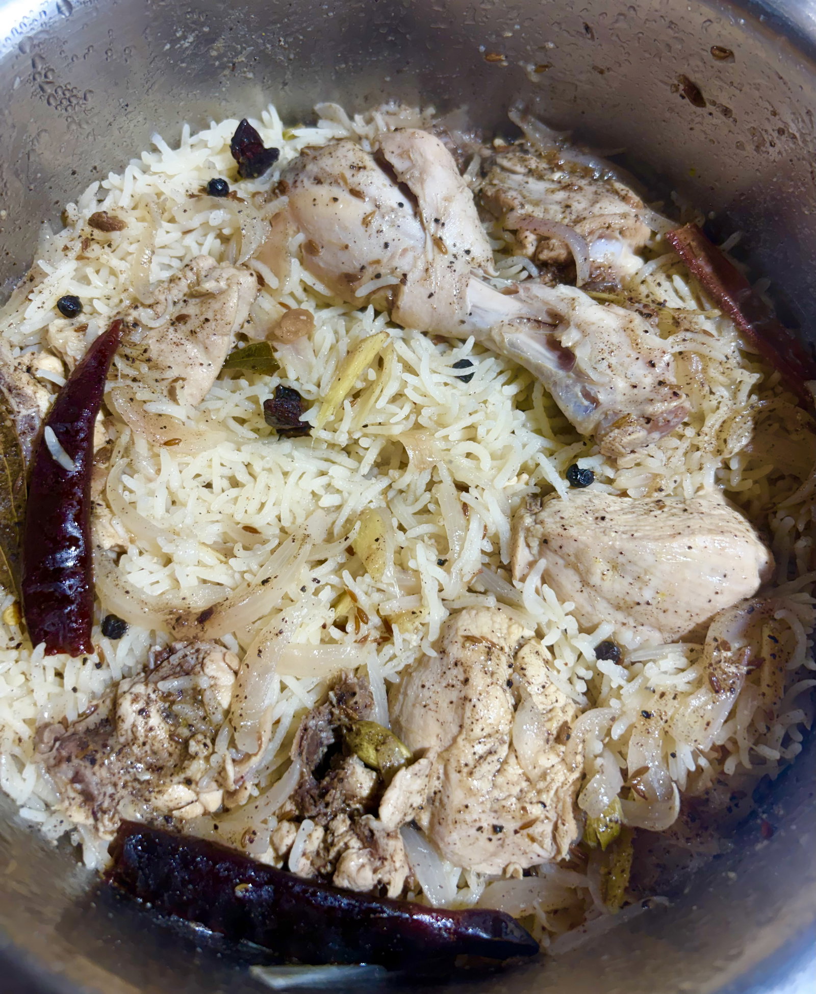 Step 1.1: Reduce the heat to medium-low, cover with a tight lid, and simmer until the water is completely absorbed and the chicken and rice are fully cooked