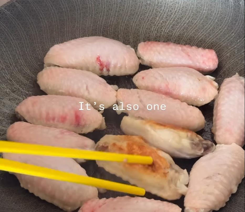 Step 1.1: Heat a wok over medium-high heat, add a bit of oil, and cook the chicken wings until golden on both sides