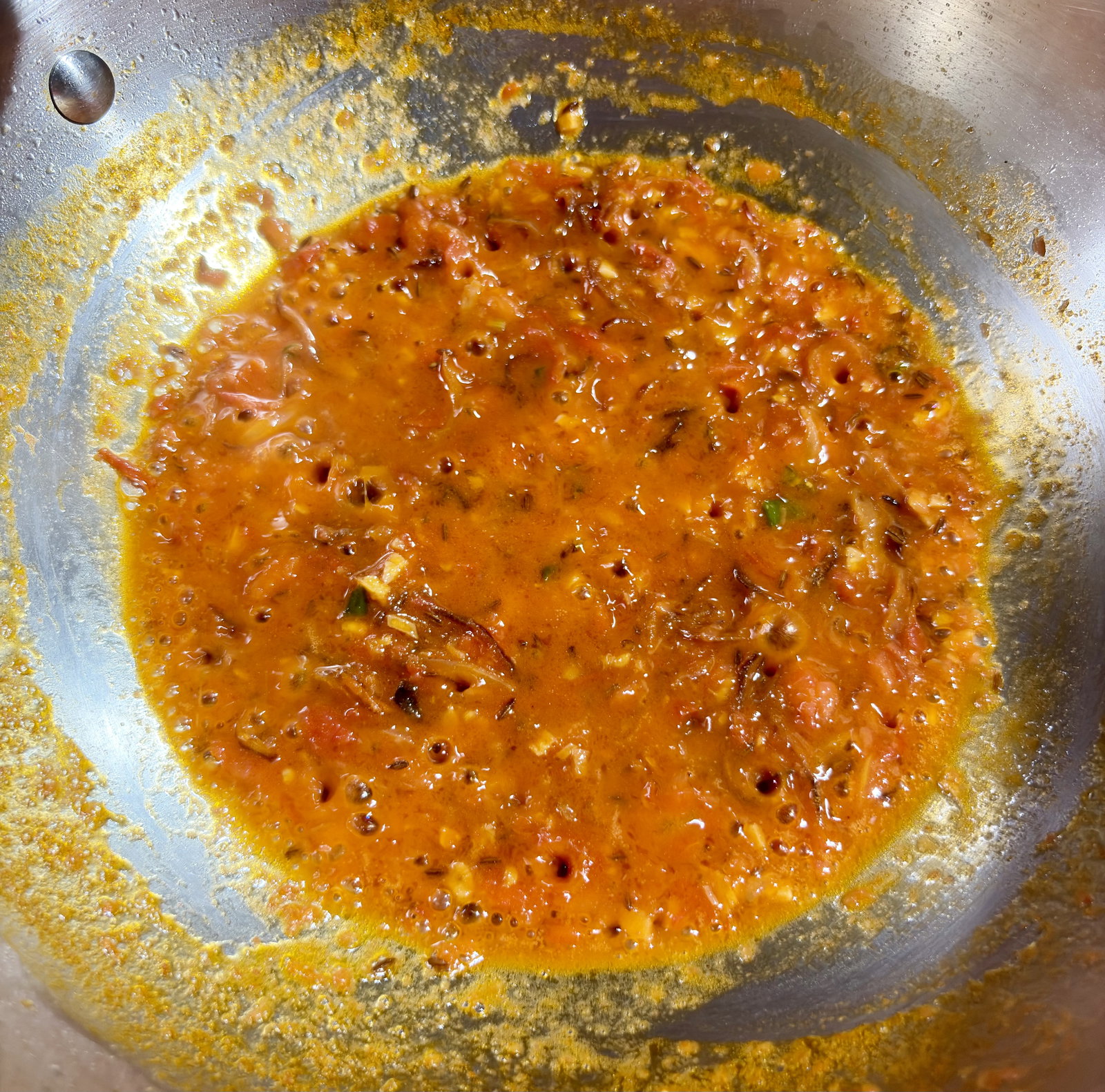 Step 2.2: Add the tomatoes and cook until they soften and the ghee begins to separate from the sides