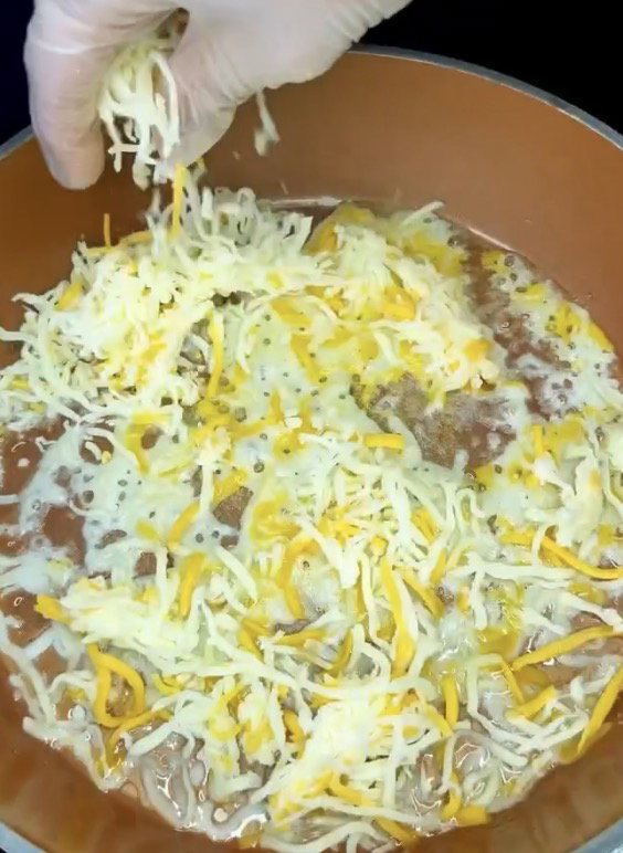 Step 1.1: Sprinkle shredded mozzarella evenly into the pan