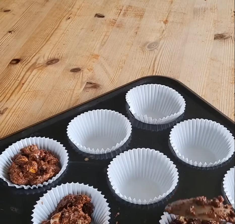 Step 1.1: Spoon the mixture into cake cases and press a few mini eggs on top
