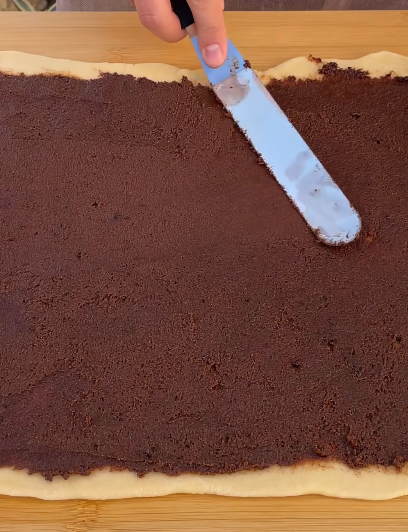 Step 3.1: Spread the cinnamon filling evenly over the dough
