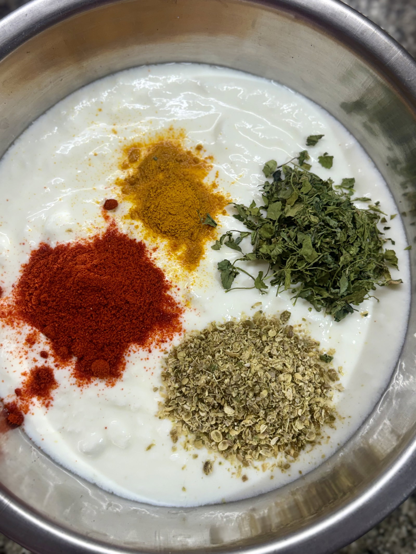 Step 3.1: In a bowl, whisk curd with coriander powder, Kashmiri chilli powder, kasuri methi, and turmeric