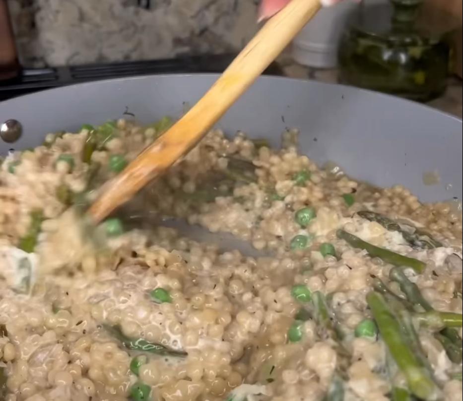 Step 3.1: Mix in heavy cream, frozen peas, and grated Parmesan into the couscous mixture