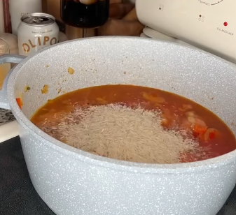 Step 2.2: Mix in crushed tomatoes, chicken stock, and rice