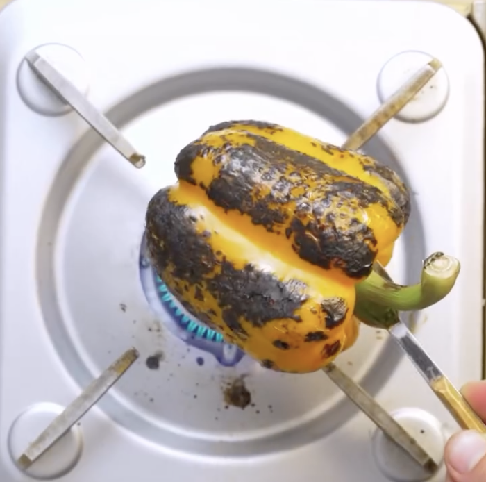 Step 1.1: Char the bell peppers directly over an open flame until the skin blackens, then cool in cold water and peel
