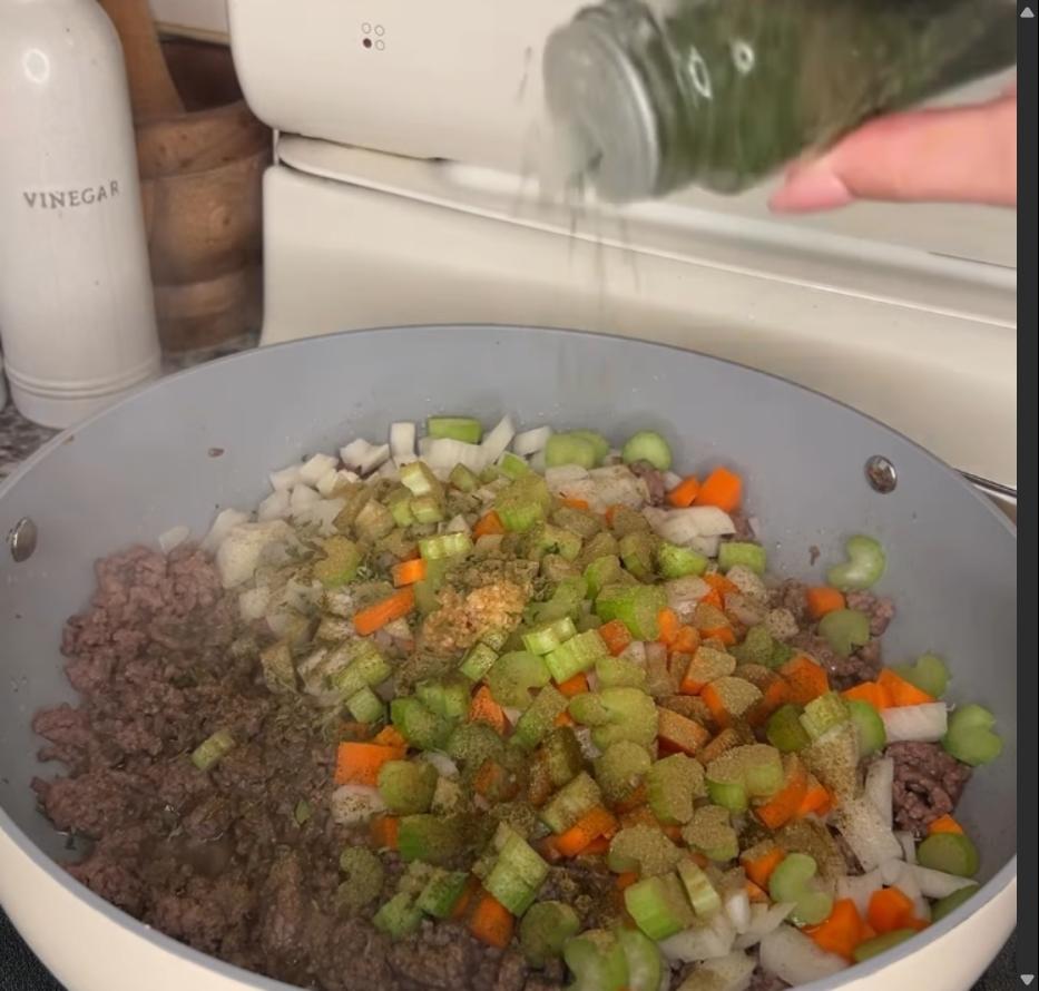 Step 1.1: Add onions, carrots, celery, garlic, thyme, parsley, oregano, salt, and pepper