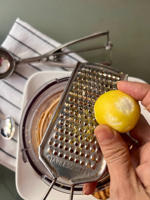 Step 6.1: Mix in the lemon zest & scoop into serving bowls