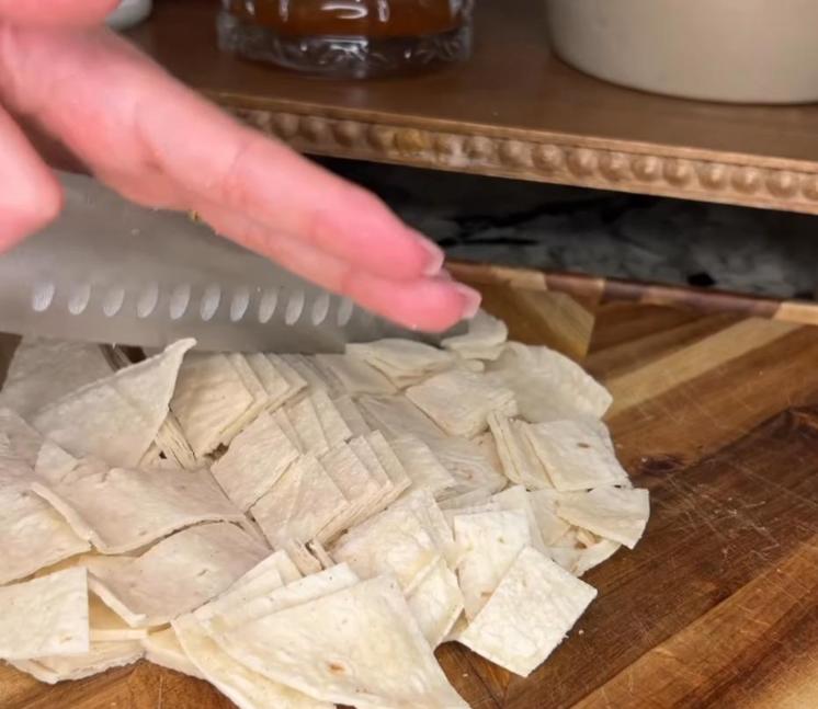 Step 1.1: Cut corn tortillas into squares and mix about half into the meat and sauce mixture