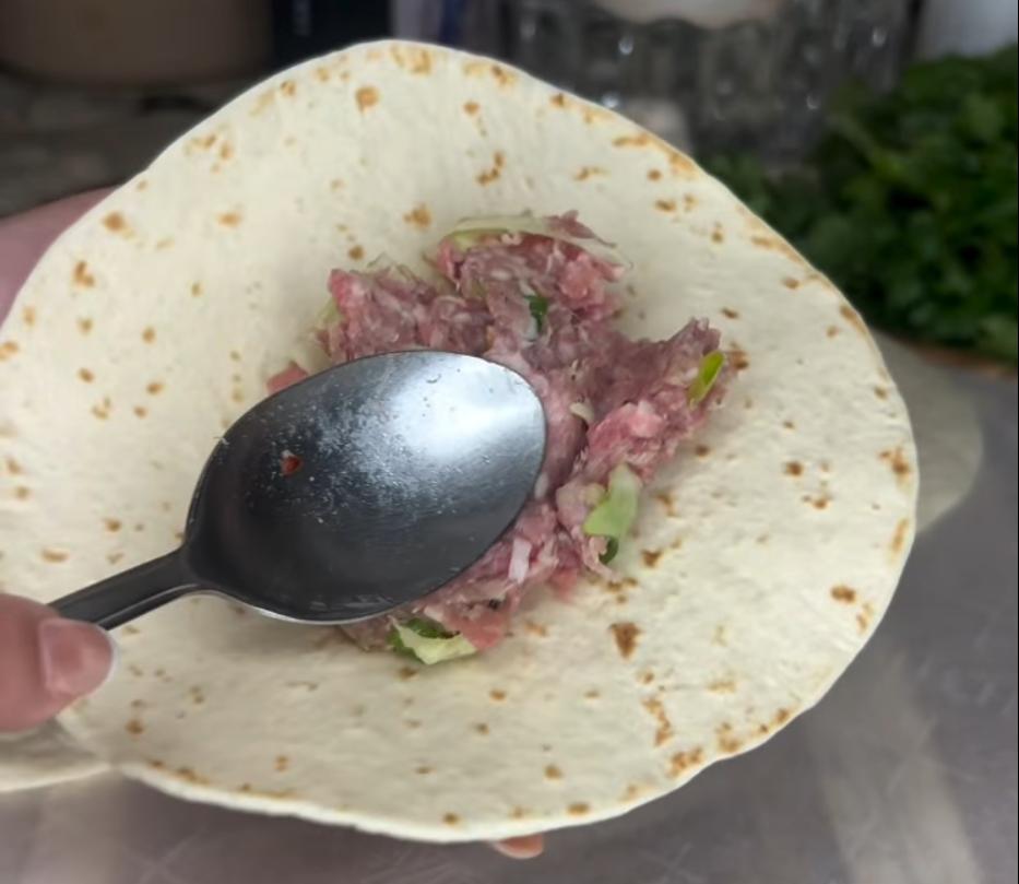 Step 2.1: Spread the pork mixture evenly in a thin layer onto each flour tortilla
