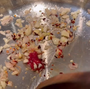 Step 1.1: Add red pepper flakes and tomato paste, stir to combine