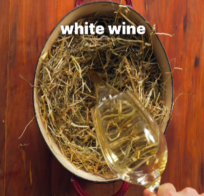 Step 2.1: Heat a heavy cocotte on the stove, add a layer of hay at the bottom, and pour in the dry white wine