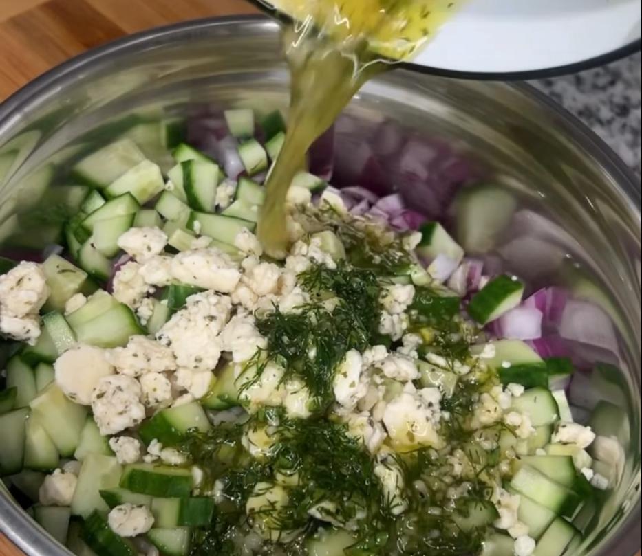 Step 2.1: In a large bowl, combine cooked couscous, diced red onion, cucumber, cheese crumbles, and lemon herb dressing