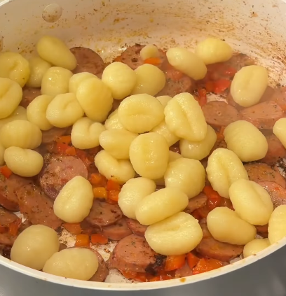 Step 1.1: Turn off the heat, add gnocchi and pesto to the skillet, and toss everything together until glossy and coated