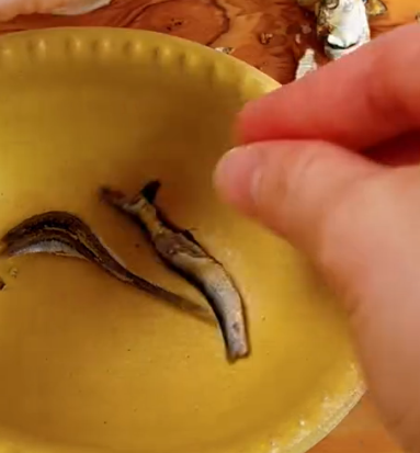 Step 1.1: Remove the heads and guts from the dried sardines