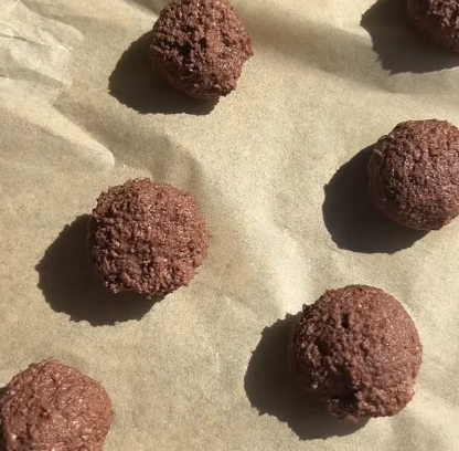 Step 3.1: Add a piece of chocolate to the center of each flattened ball, then roll it back into a ball shape