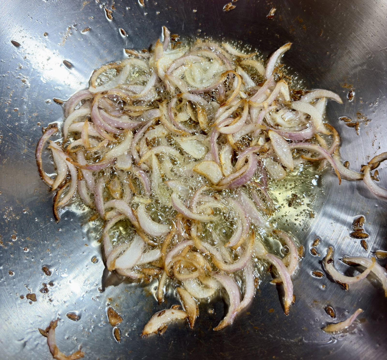 Step 2.1: Add the sliced onions and sauté until the edges turn golden brown