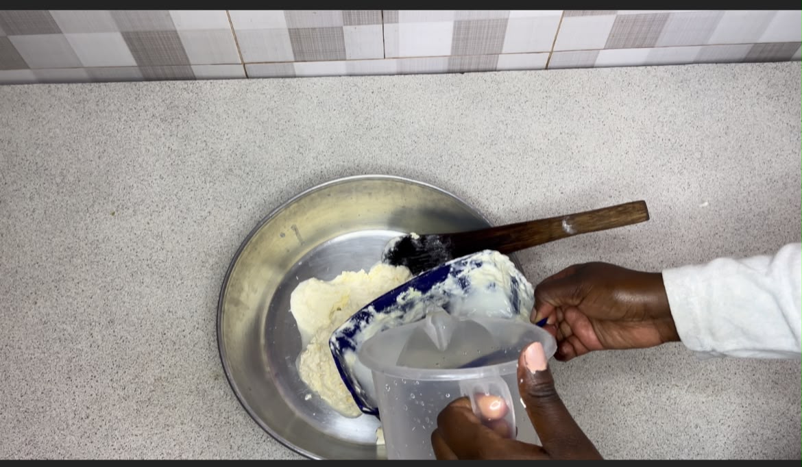 Step 1.1: Using a Mwiko (wooden spoon ) whisk the cream vigorously