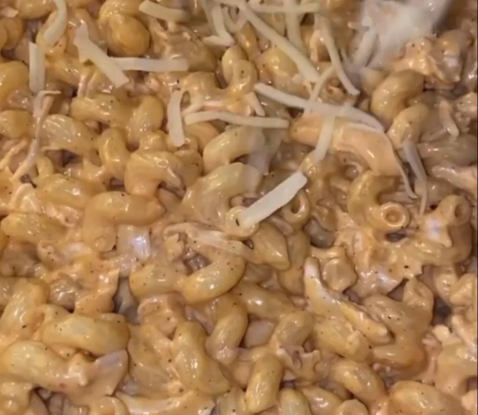 Step 1.1: Transfer the pasta mixture into a greased tray, then top with extra cheese and bread crumbs