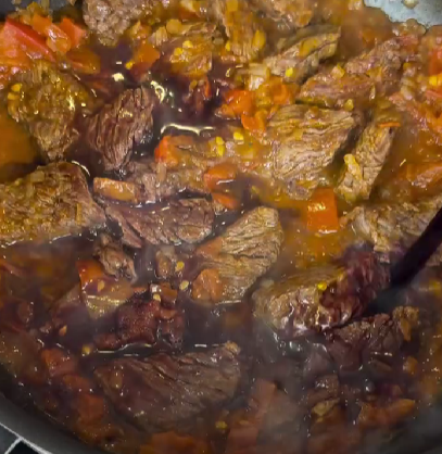 Step 1.1: Stir in the tomato, red wine, and water, scraping up all those flavorful bits