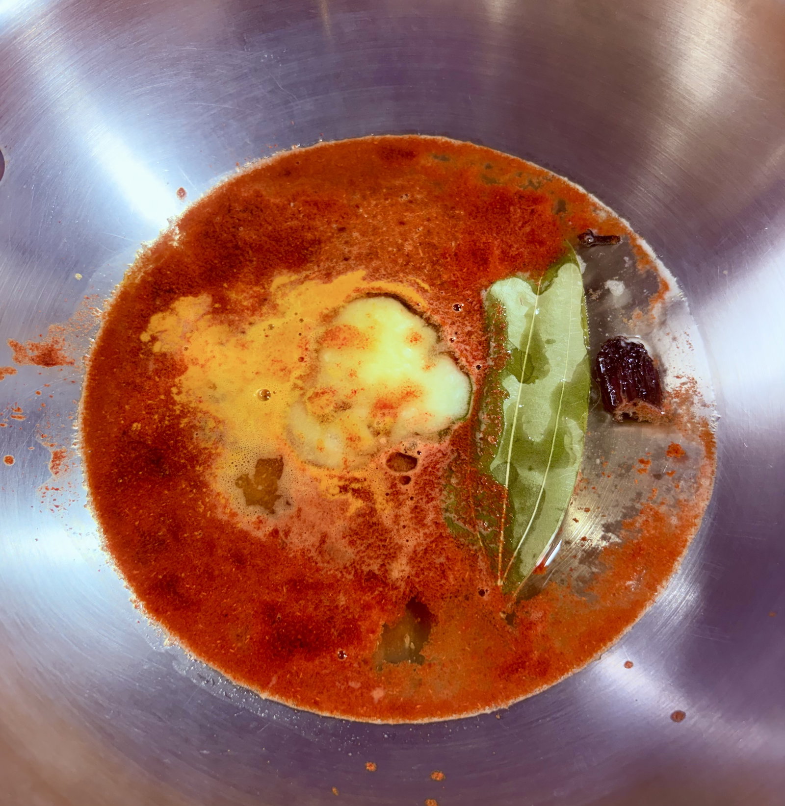 Step 4.1: In a deep handi or kadhai, add water, ghee, bay leaf, black cardamom, cloves, red chilli powder, Kashmiri red chilli powder, turmeric, and asafoetida