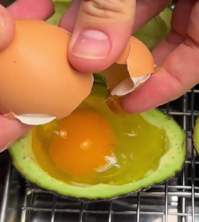 Step 1.1: Crack one egg into each avocado half