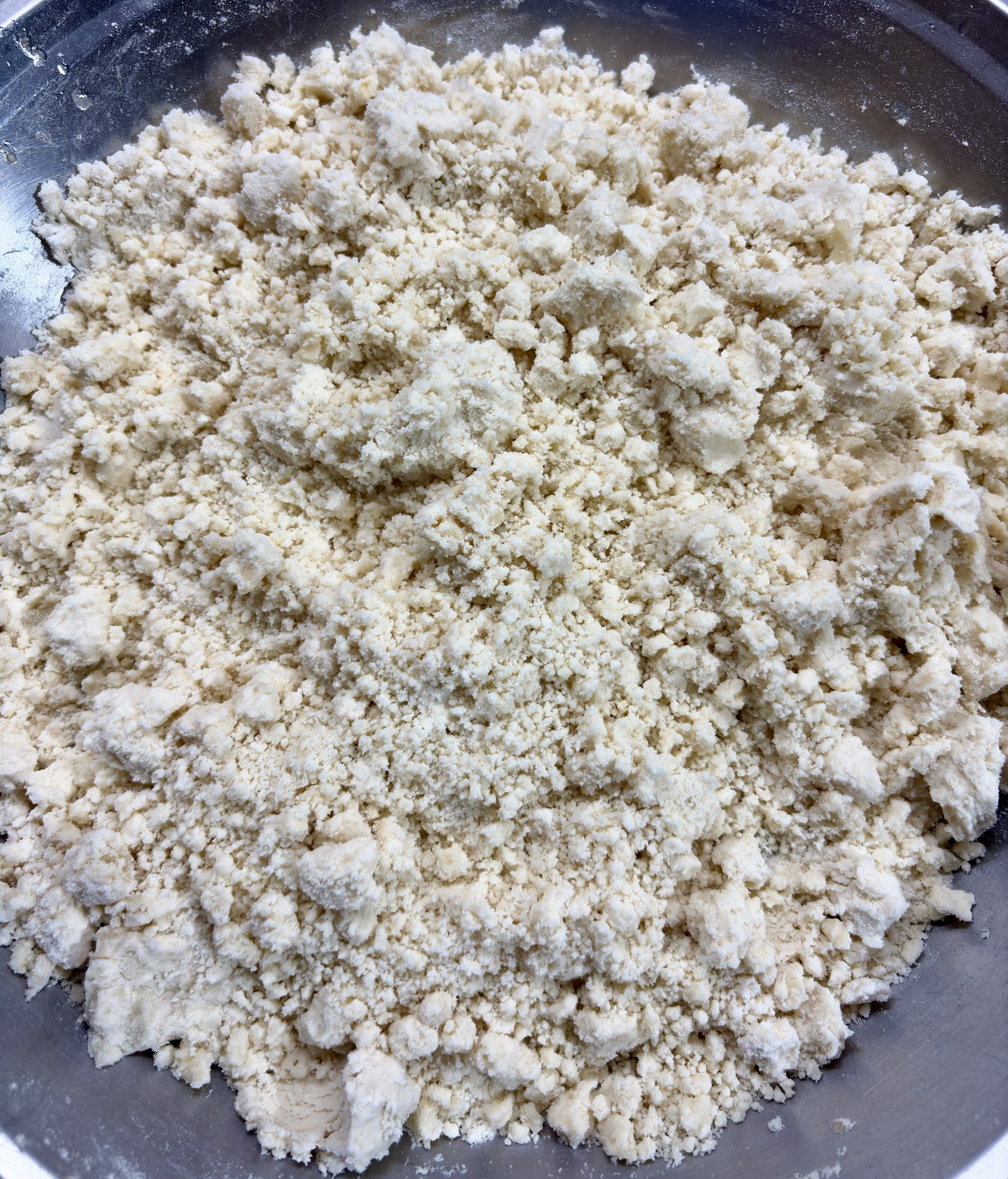 Step 2.2: Add ghee to the flour mixture and mix with light hands until it becomes crumbly
