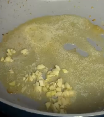 Step 2.1: Melt butter in a skillet over low heat with the smashed garlic cloves