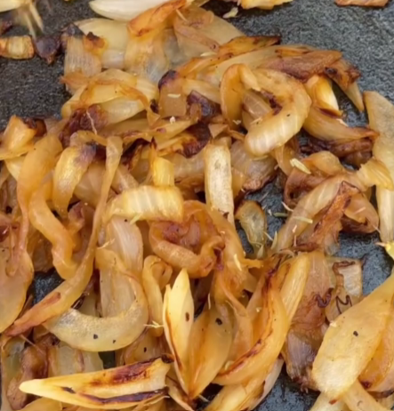 Step 1.1: Add sliced onions and a pinch of salt, then cook for 20–25 minutes until golden and softened