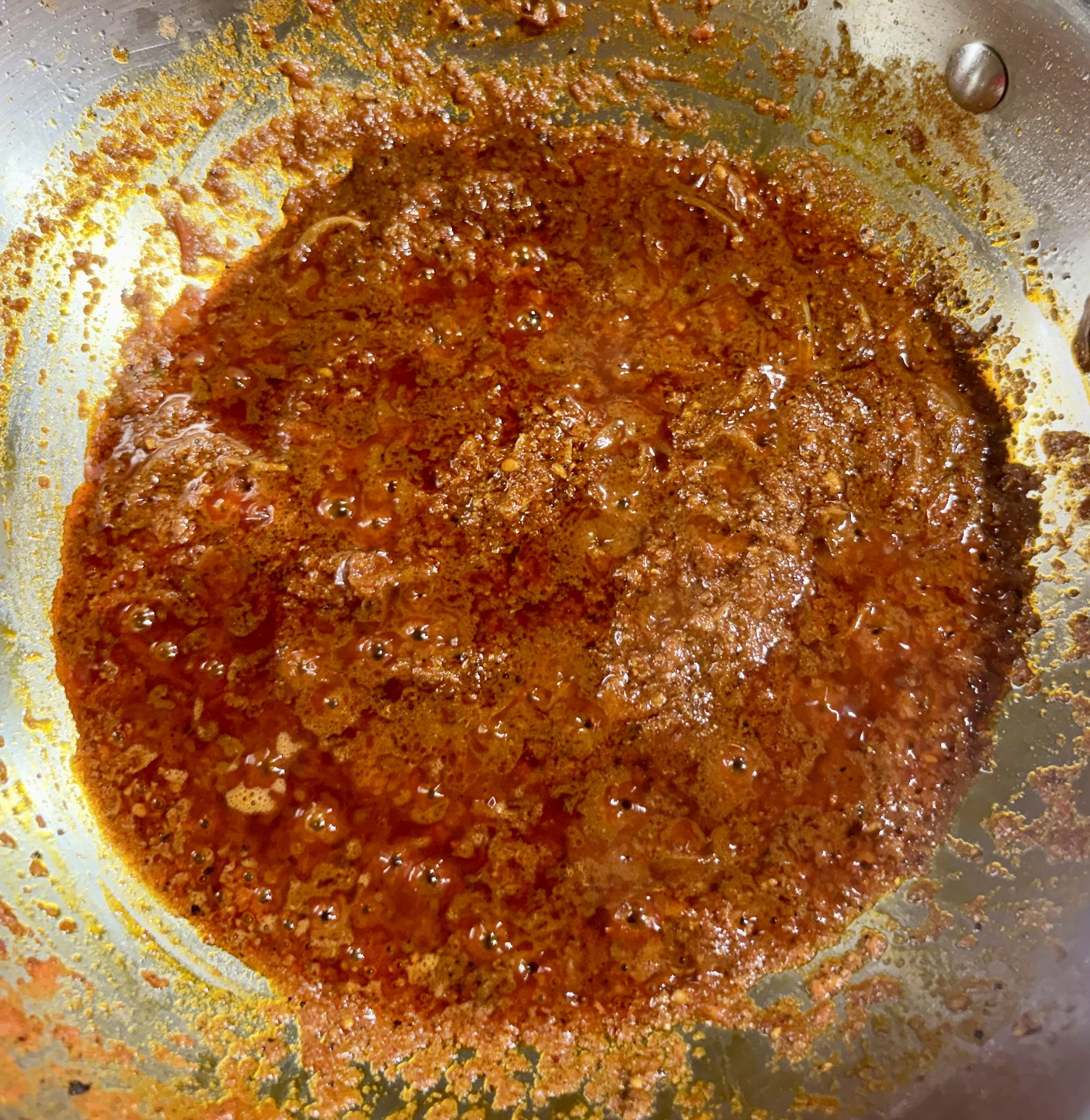 Step 2.1: Add the ground tomatoes and cook until oil begins to separate from the masala