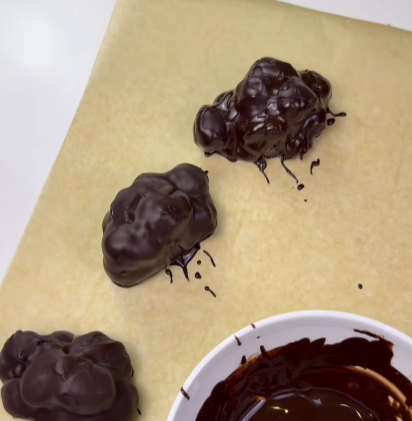 Step 1.1: Dip each frozen cluster into the melted chocolate, ensuring it is fully coated
