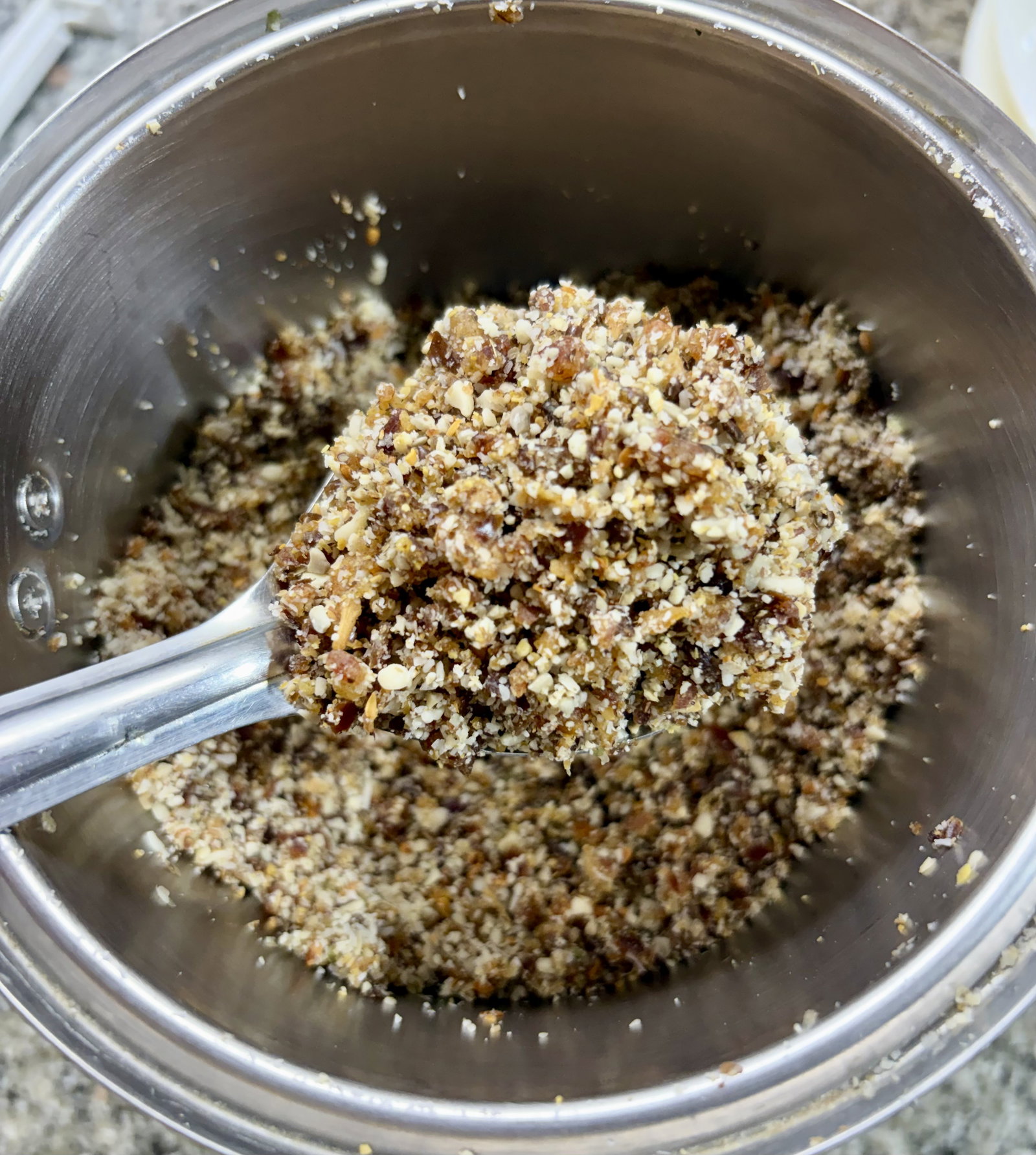 Step 2.3: Combine the soft dates, cooled toasted seeds, roasted peanuts, desiccated coconut, olive oil, ground cardamom, and salt in a food processor