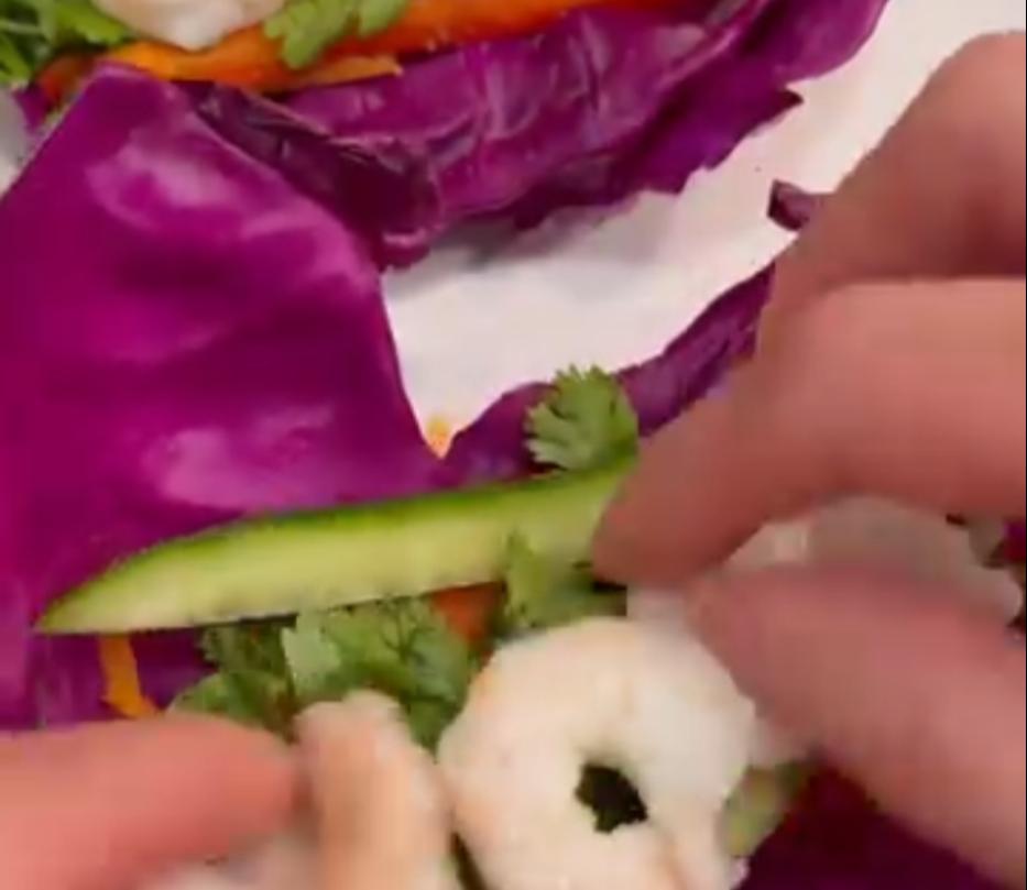 Step 3.1: Layer cucumber, shredded carrots, avocado slices, shrimp, cilantro, and bell pepper on the leaf