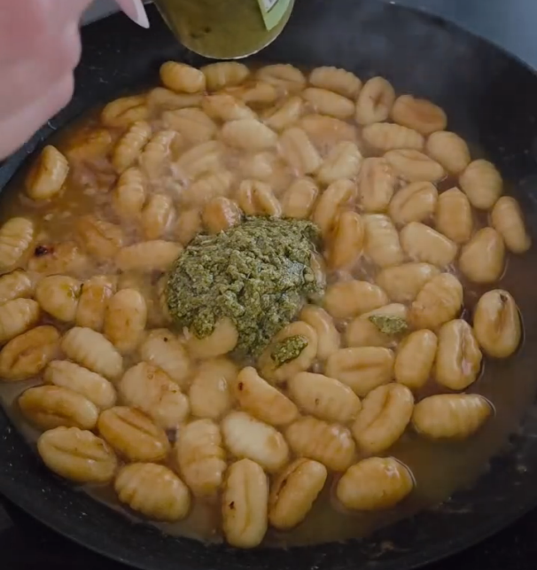 Step 1.1: Add the chicken stock to the pan, followed by the pesto, and mix to combine