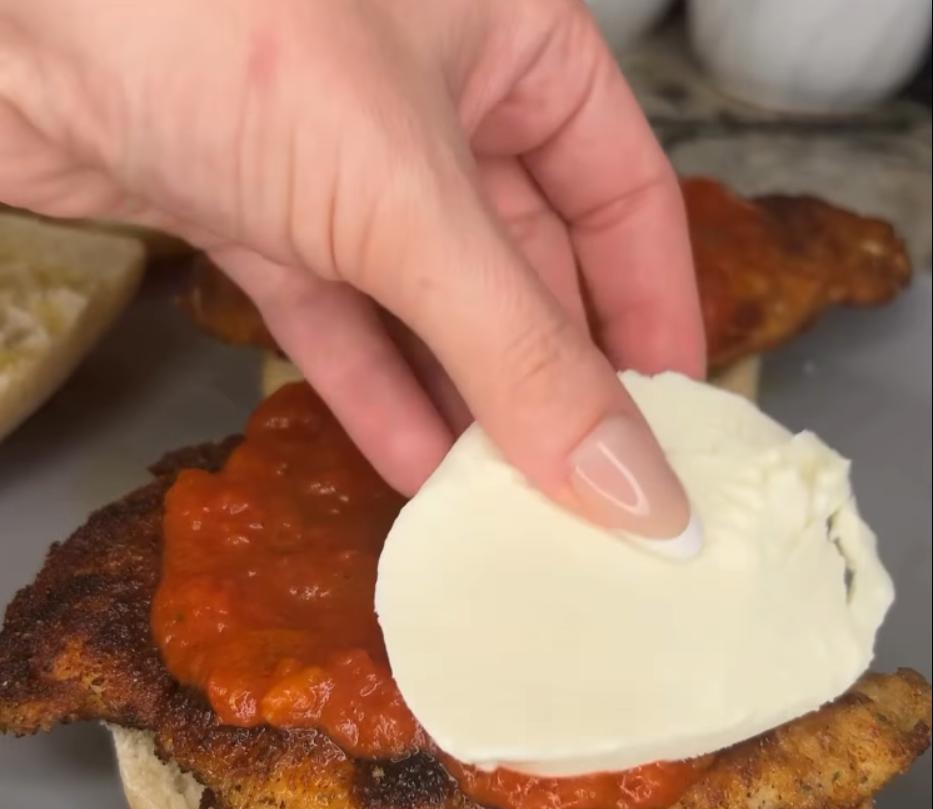 Step 2.1: Place fried chicken, marinara sauce, and mozzarella on the bottom half of the ciabatta roll