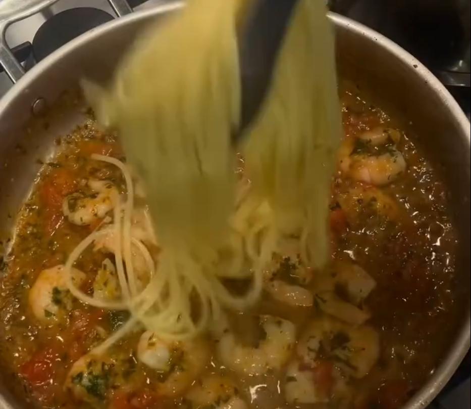 Step 1.1: Toss the drained spaghetti through the sauce with a splash of pasta water