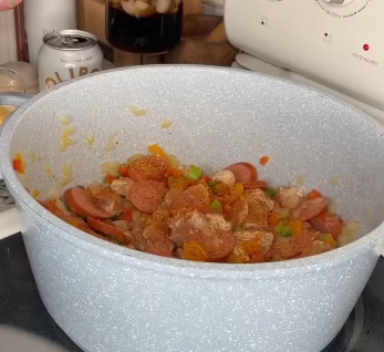 Step 2.1: Add sausage and chicken to the pan, and season with creole seasoning, basil, and thyme