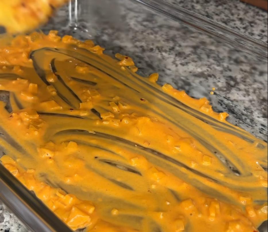 Step 4.1: Spread a spoonful of sauce at the bottom of a baking dish