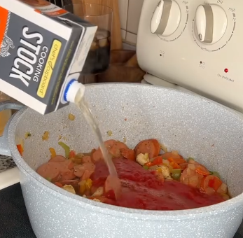 Step 2.1: Mix in crushed tomatoes, chicken stock, and rice