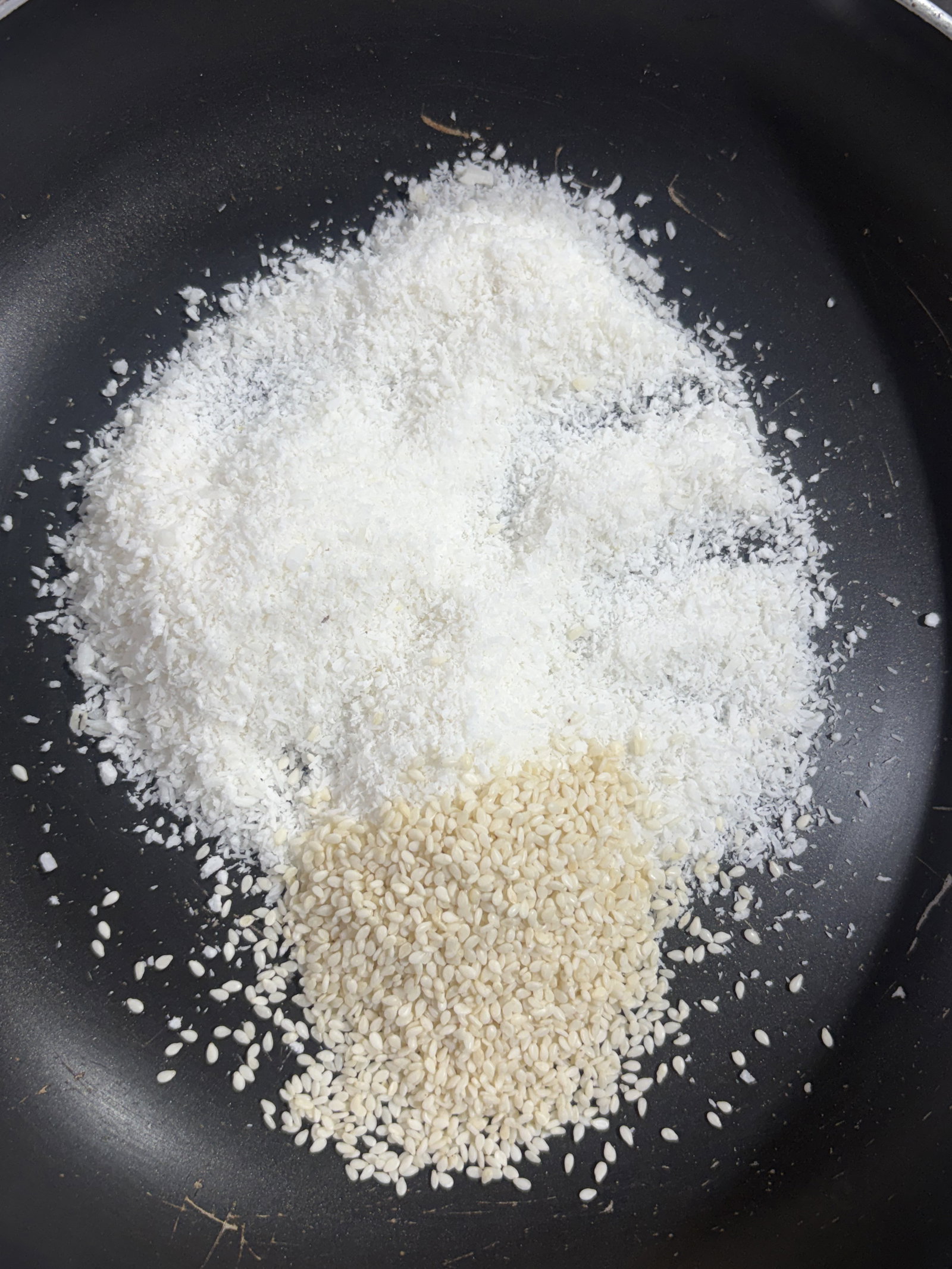 Step 1.1: In a pan over low heat, dry roast the desiccated coconut and sesame seeds